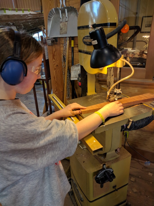 Emilia cutting her frame on the bandsaw