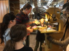 Lara orients our new girls to the bandsaw