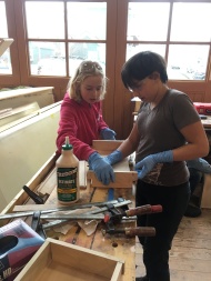 Fiona and Chloe work together to glue up